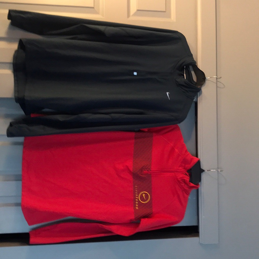 Two Women’s Nike Pro Dri-Fit running jackets.